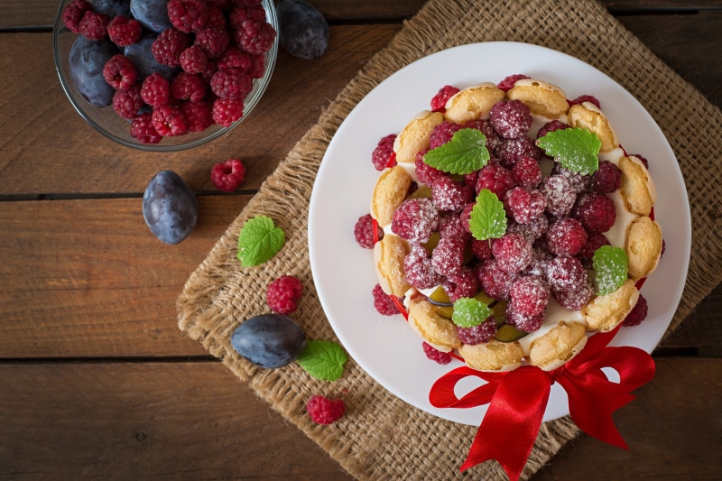 Raspberry and Plum Dessert on a Plate with Red Ribbon