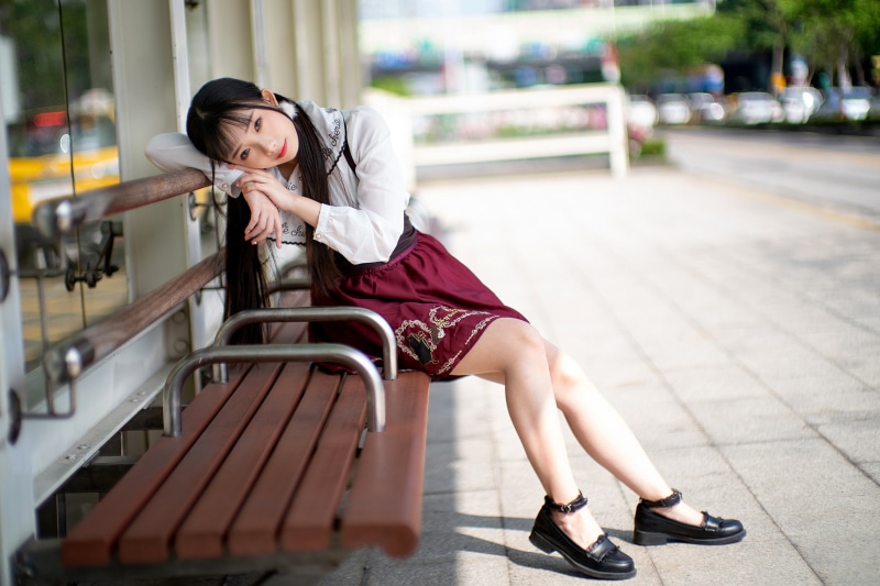 Asian Girl Sitting on a Bench