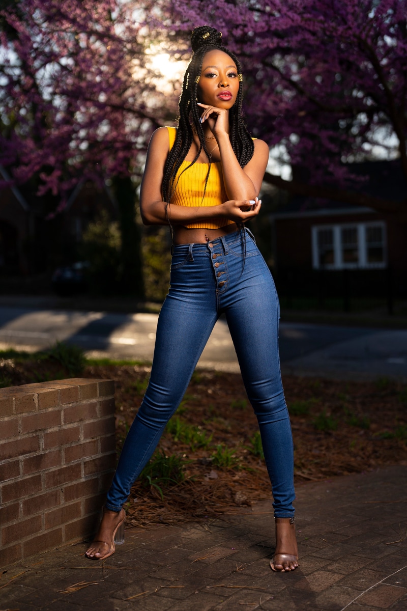Janae Fulton posing in jeans and a yellow top