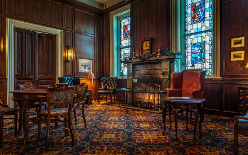 Interior room with fireplace, stained glass windows, and furniture
