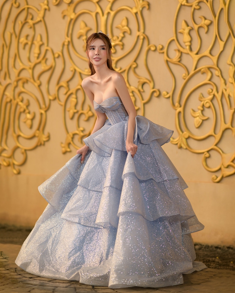 Asian woman in a sparkly blue ball gown