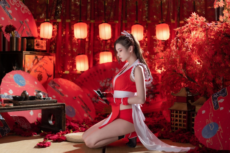 Woman in Red Outfit with Lanterns and Umbrellas
