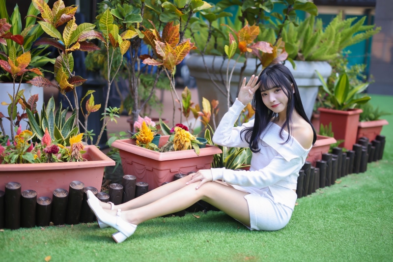 Brunette girl sitting in garden