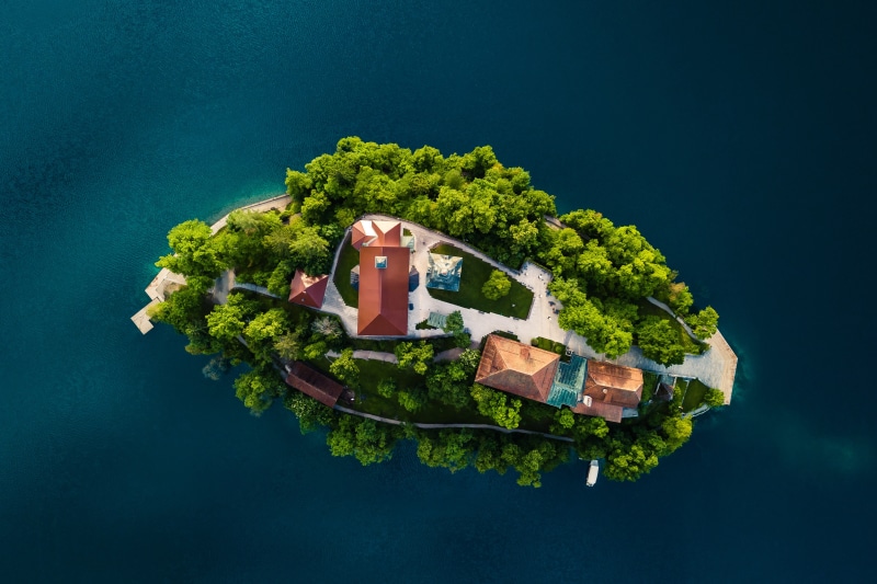 Aerial view of Bled Island with buildings and trees in Slovenia