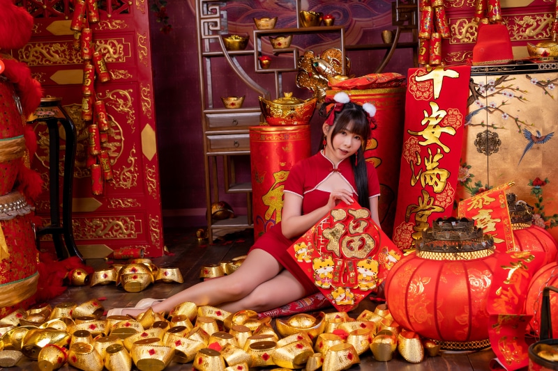 Asian woman in red dress with Chinese New Year decorations