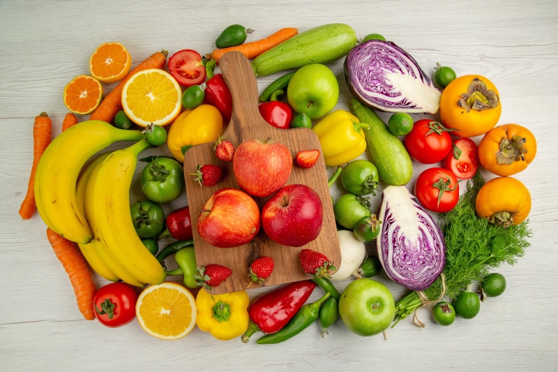 Assortment of Fruits and Vegetables with Cutting Board