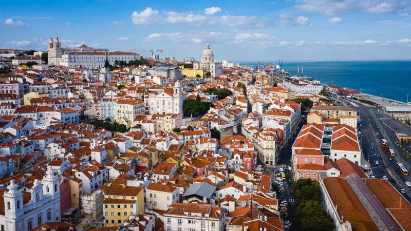 Lisbon, Portugal cityscape with river and bridge