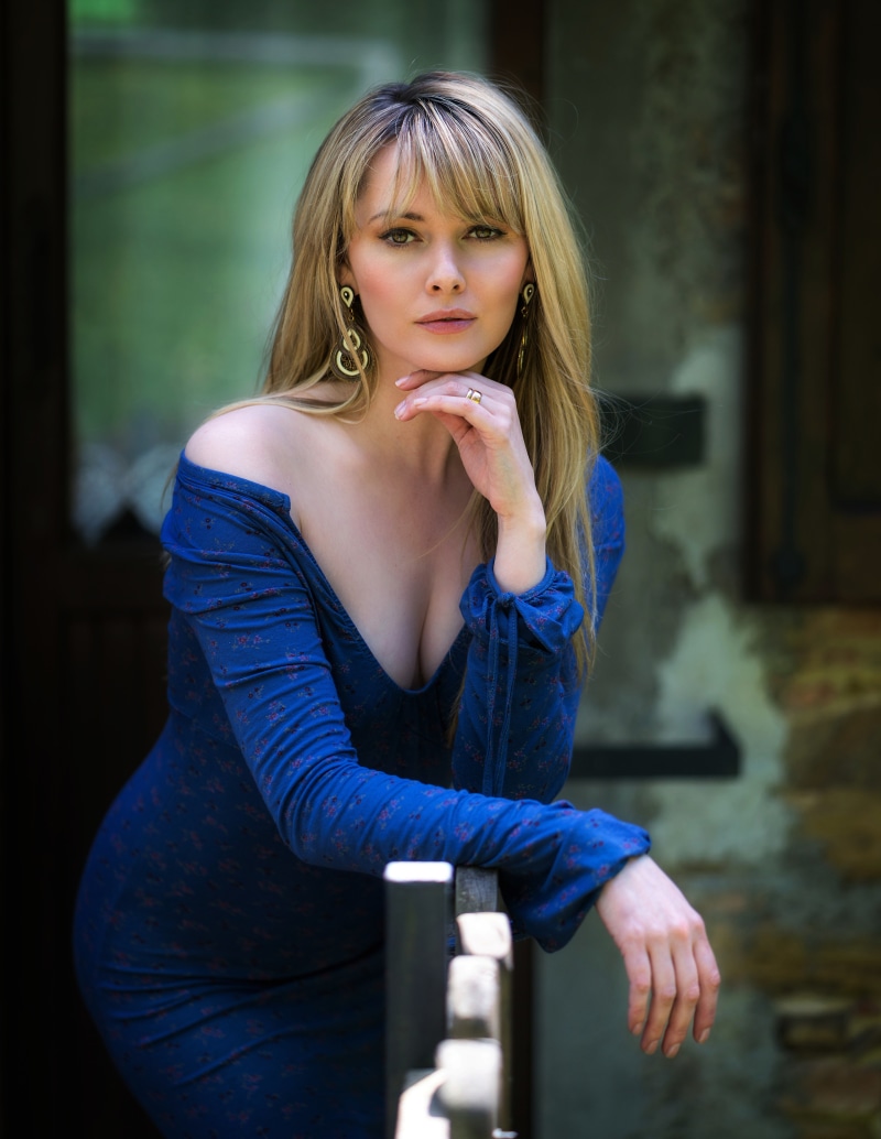 Carla Monaco posing in a blue dress
