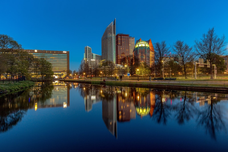 The Hague skyline reflected in a canal at dusk
