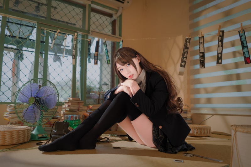Asian girl in stockings and skirt posing