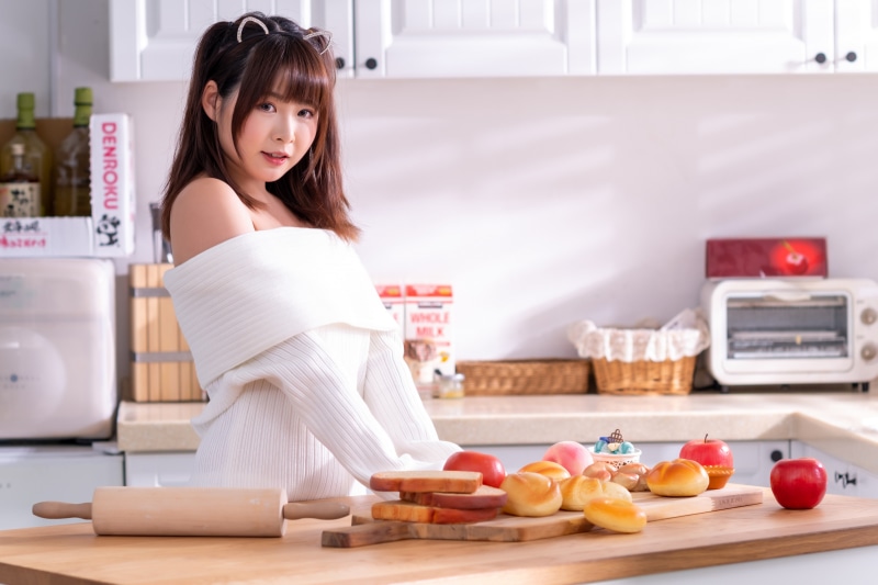 Asian woman in kitchen with baked goods