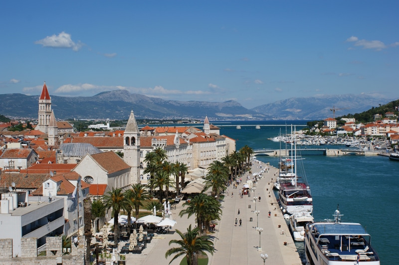 Trogir, Croatia waterfront with boats and mountains