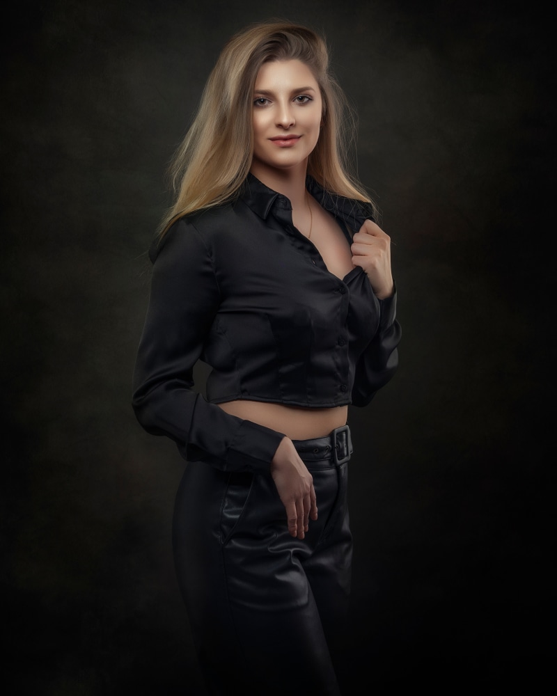 Klaudia in a black blouse and trousers