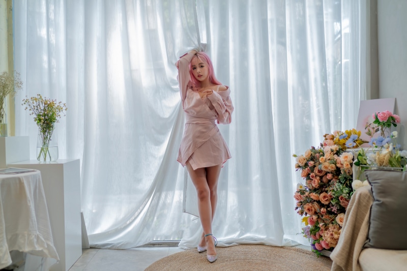 Asian woman in pink dress posing