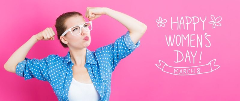 Woman flexing on pink background with Happy Women's Day text