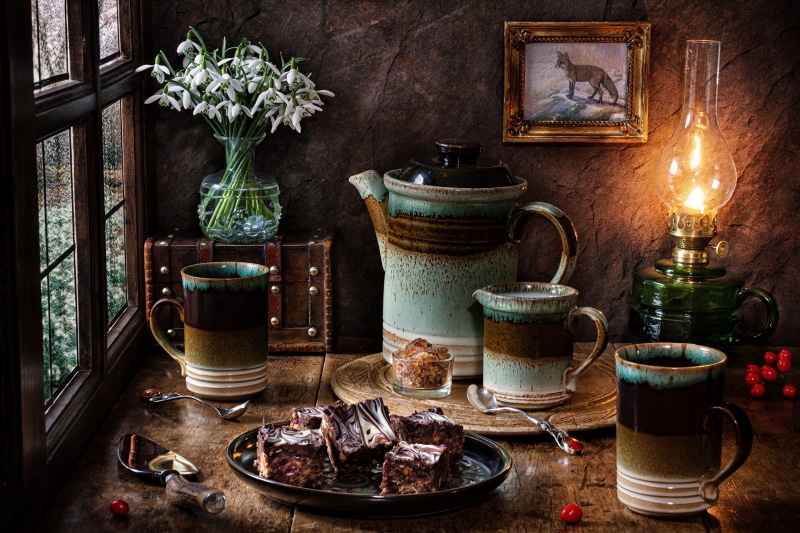 Still-life with snowdrops, cakes, and a kerosene lamp