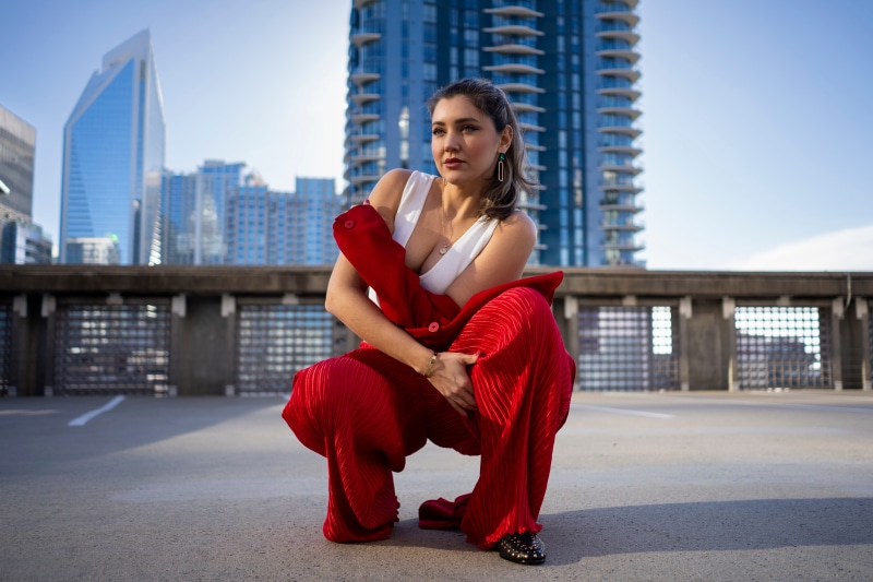 Woman in red outfit posing on rooftop