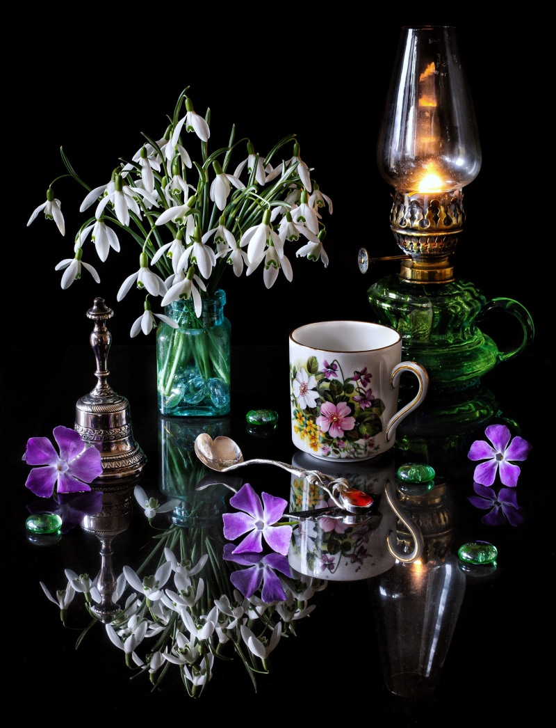 Still life with snowdrops, mug, and kerosene lamp