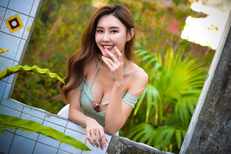 Asian woman with brown hair smiling