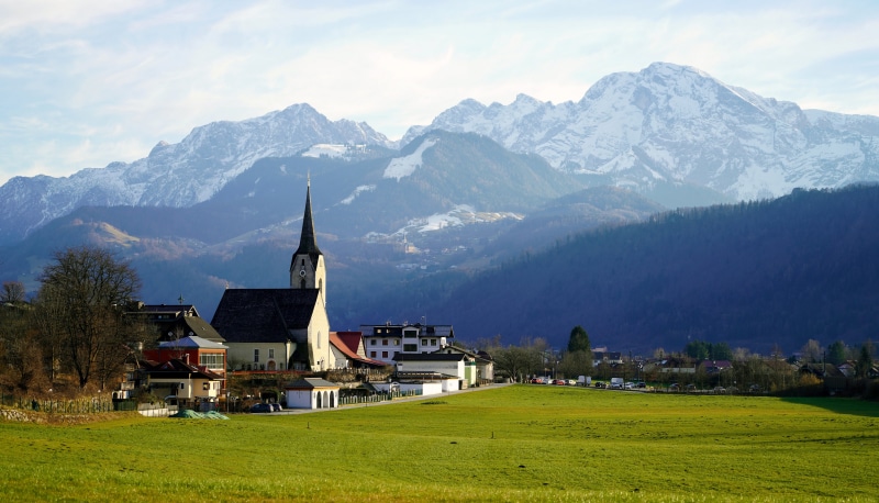 Village with Church and Snow-Capped Mountains in Austria