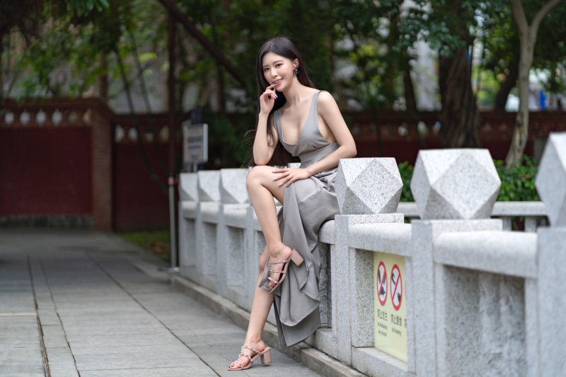 Brunette girl in a dress posing outdoors