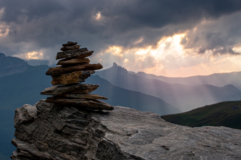 Stacked stones on a rocky outcrop in the Swiss Alps