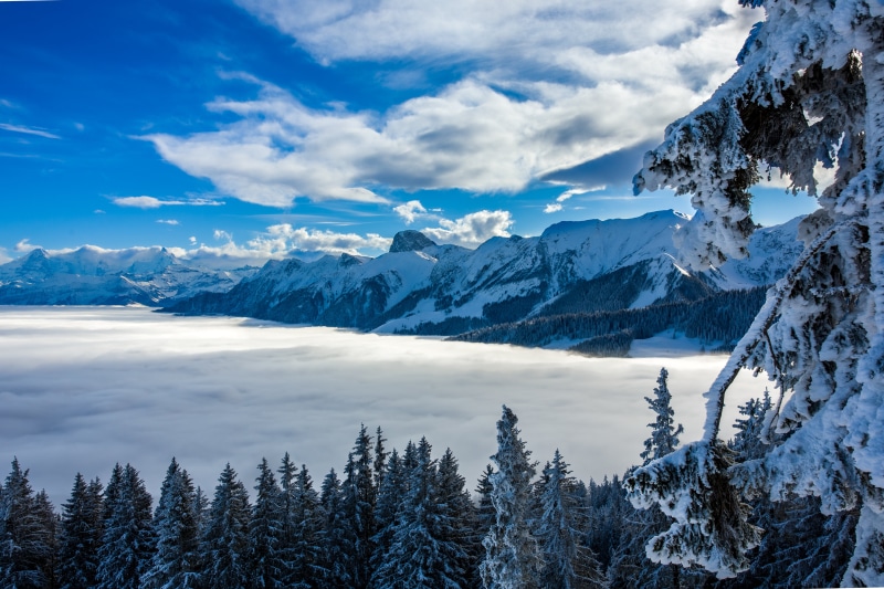 Snowy mountains above clouds in Switzerland