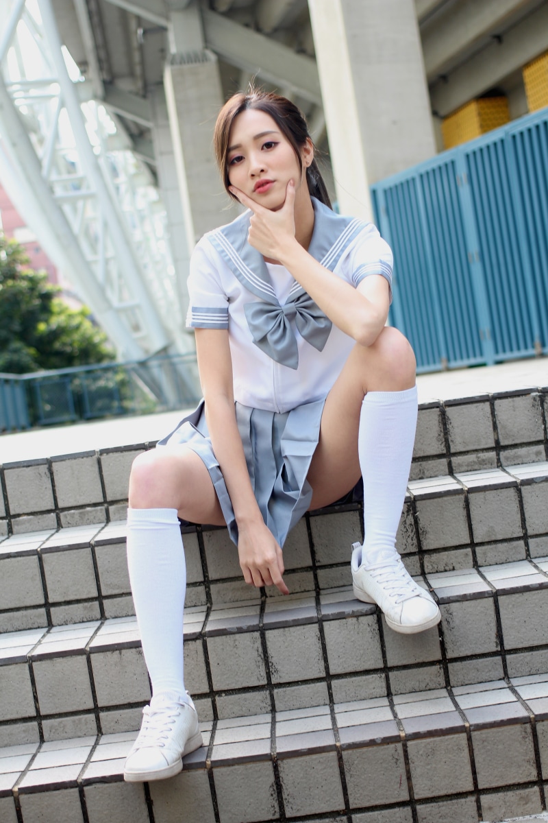 Asian schoolgirl sitting on stairs