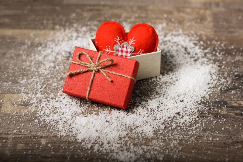 Red gift box with hearts and snow