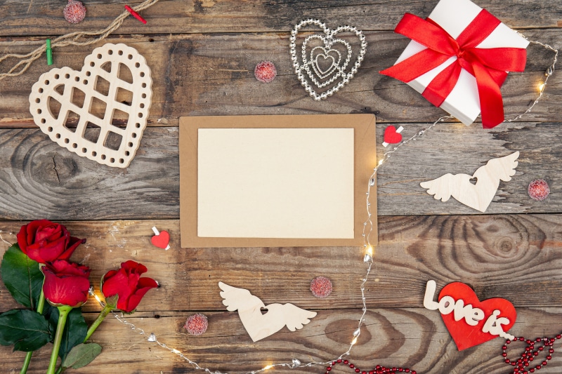 Valentine's Day flat lay with roses, gift box, and hearts