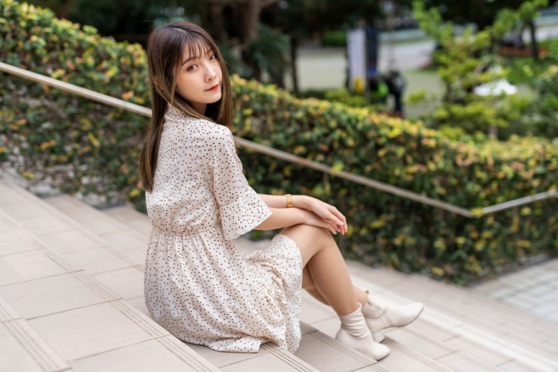 Asian woman sitting on stairs