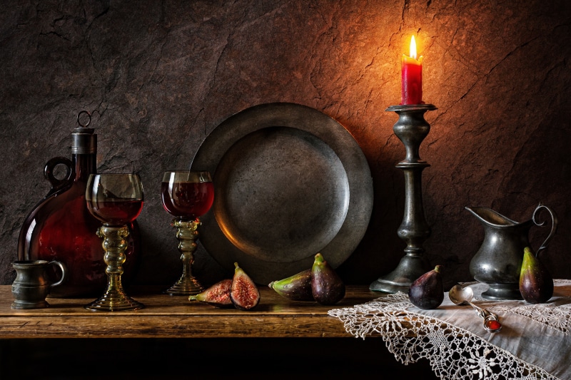 Still-life with wine, figs, and candle