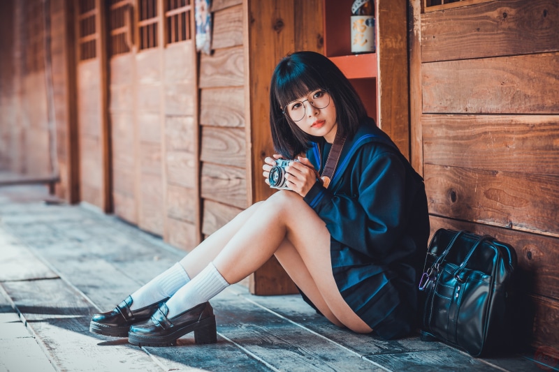 Asian girl with glasses and camera