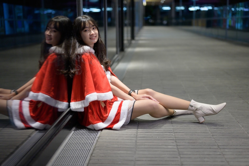 Asian girl in Santa dress with reflection