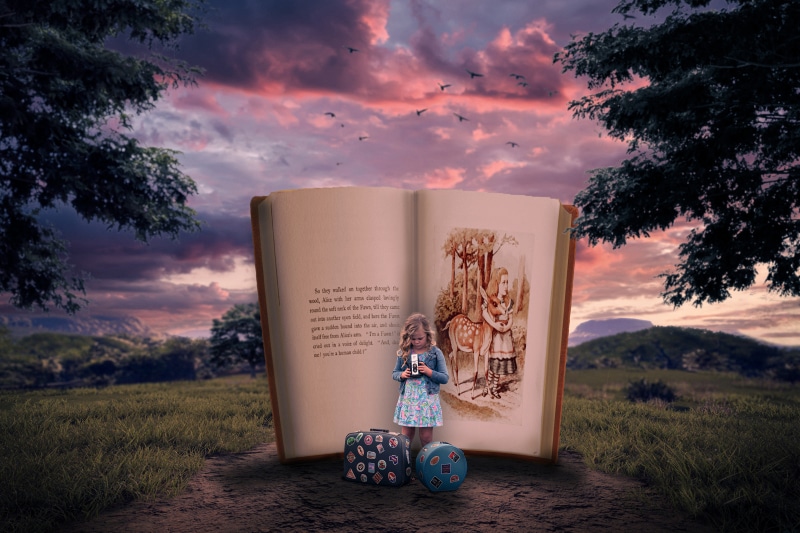 Little girl with suitcases in front of an open book