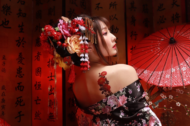Woman in Kimono with Flower Hairpiece and Tattoo