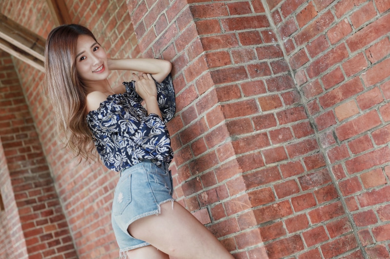 Asian Pose Wall Made of bricks Legs Shorts