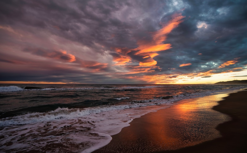 Sunset over the coast of Spain with dramatic clouds