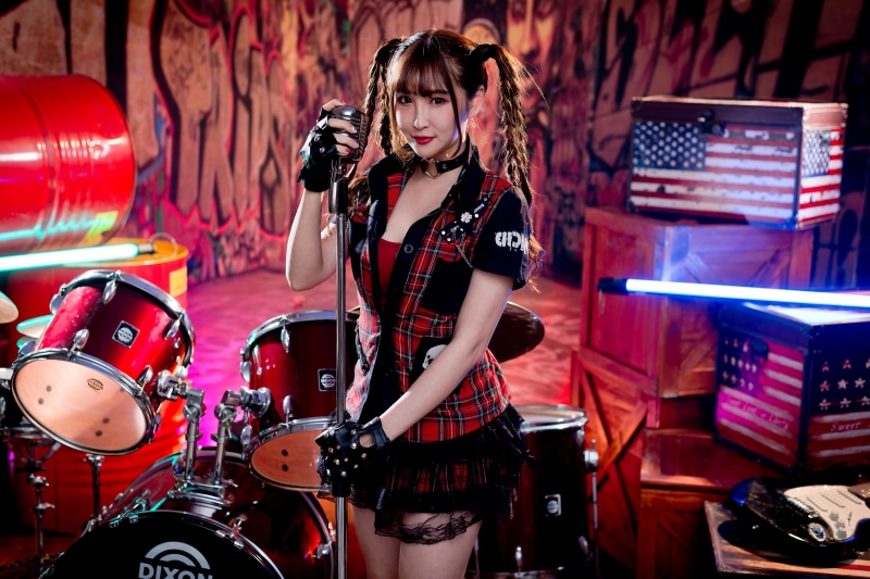 Asian woman with pigtails holding microphone