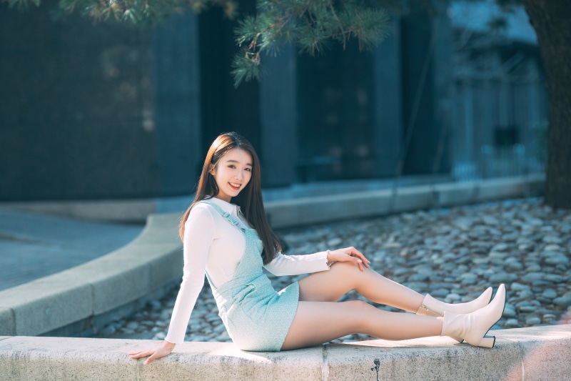 Asian woman sitting outdoors