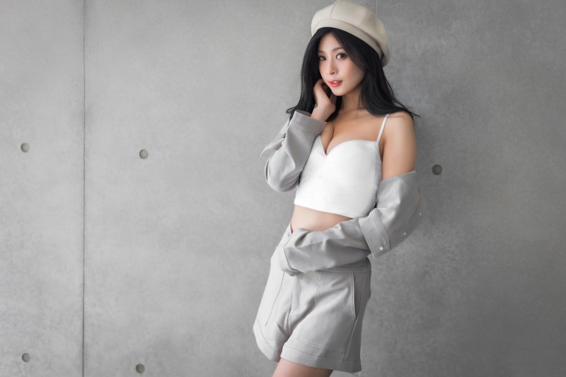 Asian woman in beret and shorts