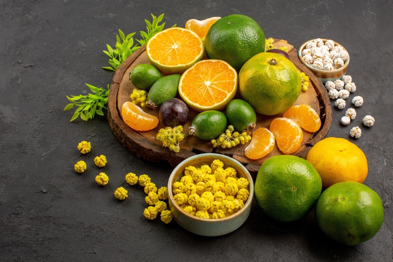 Citrus fruits and snacks on a wooden board