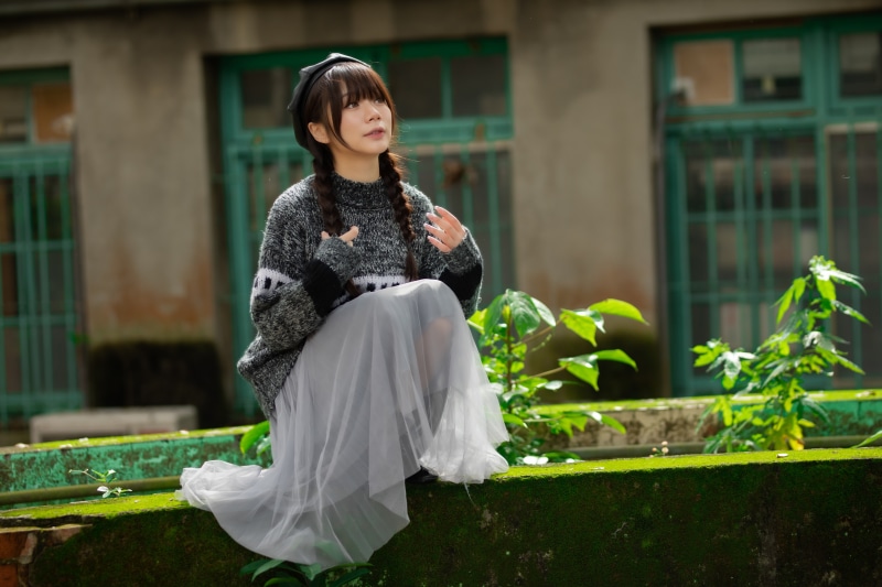 Asian girl with braid hair wearing beret and sweater