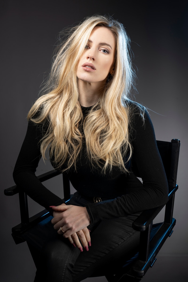 Blonde woman sitting in a director's chair