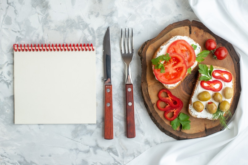 Open Notepad with Knife, Fork, and Sandwiches