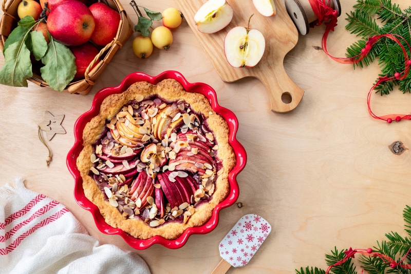 Apple pie with almonds on a wooden table