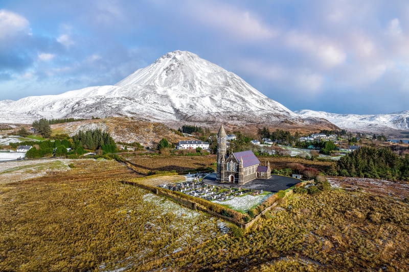 Church and snow-capped mountain in Dunlewey, Ireland