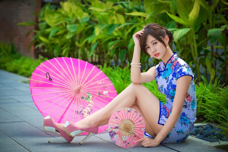 Asian woman in traditional dress with umbrellas