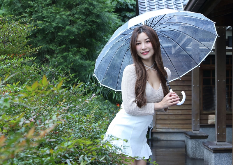 Asian Woman with Umbrella in Skirt and Blouse