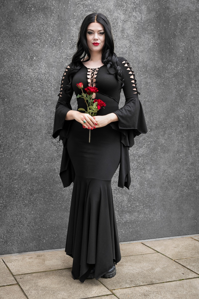 Morticia Addams holding red roses